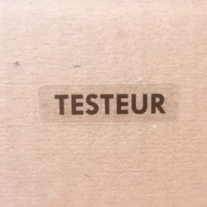 Étiquette de sécurité "TESTEUR" en noir sur fond transparent destructible format 35X10mm - bobine de 1000